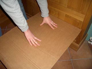 A piece of cardboard laid over a toilet bowl